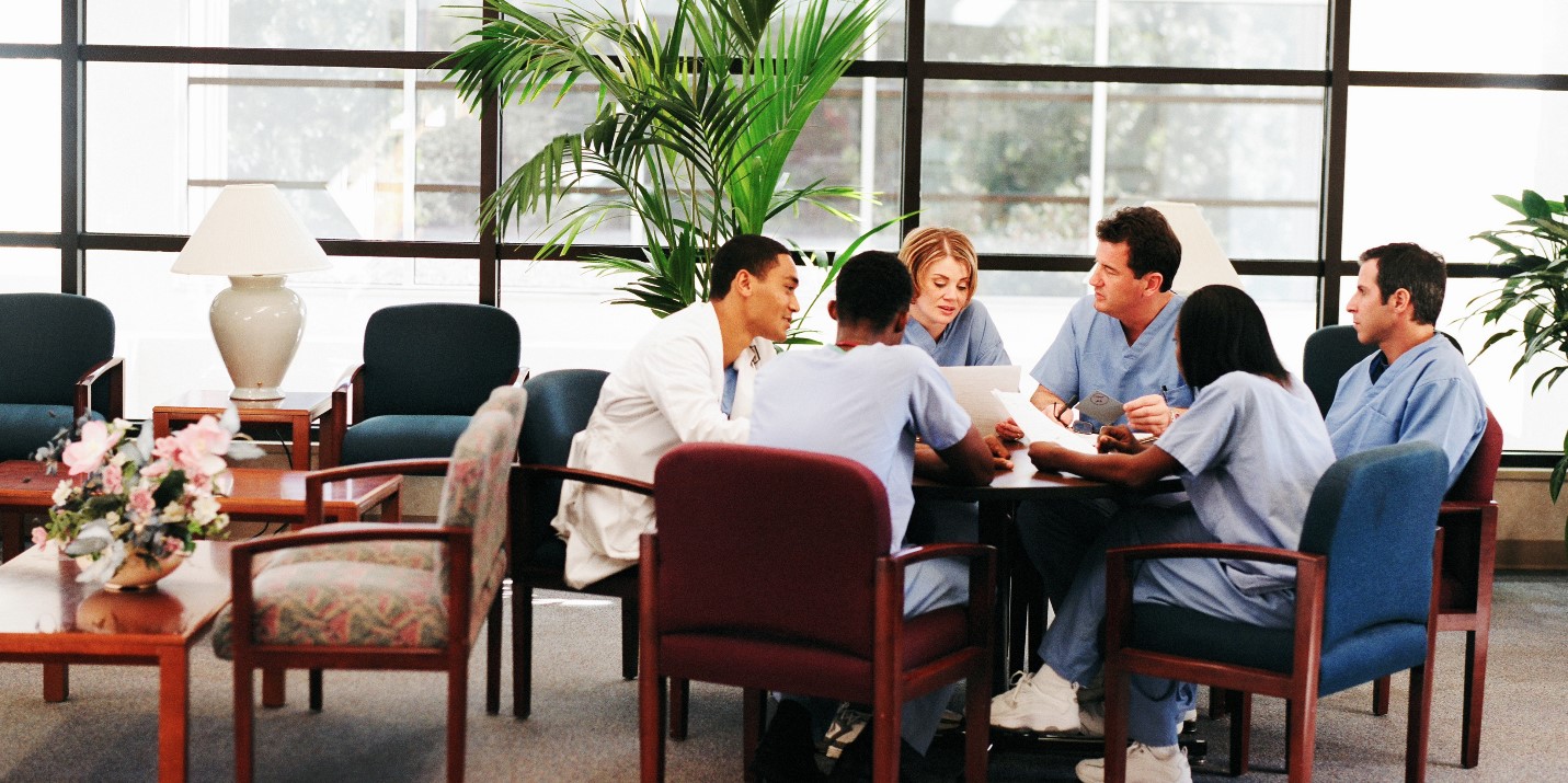 Image of physicians sitting around a table.